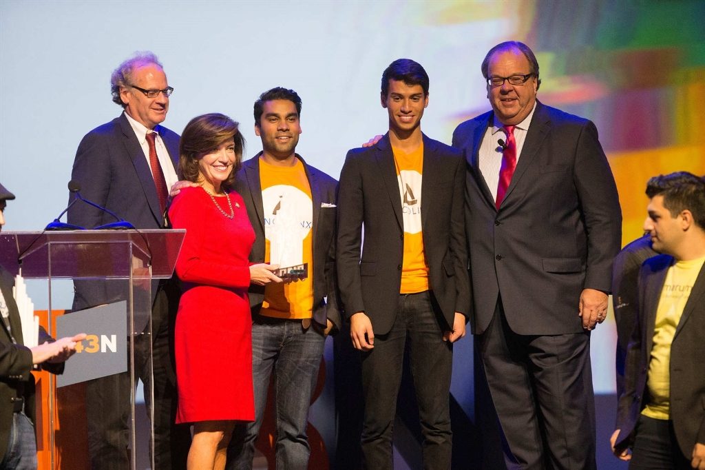 Oncolinx co-founders Sourav Sinha, CEO, left, and Riley Ennis, COO, pose for photos with Empire State Development CEO Howard Zemsky, Lt. Gov. Kathy Hochul and NYPA Chairman John Koelmel as they win the $1 million grand prize during the 43 North finals at Shea’s Buffalo Theatre, Thursday, Oct. 27, 2016.